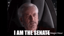 a man with a beard is sitting in a chair and says `` i am the senate '' .