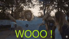 a man wearing a monkey mask stands in front of a sign that says woooo