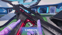 a person in purple gloves is holding a gun with the word carbon on the bottom