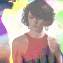 a woman in a red tank top is standing in front of a rainbow background