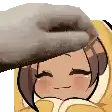 a person is petting a cartoon character 's head with a donut on it .