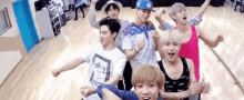 a group of young men are standing next to each other on a dance floor .