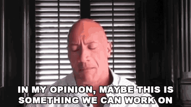 a bald man is sitting in front of a window and says in my opinion maybe this is something we can work on 