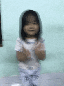 a little girl wearing a shirt that says ' snoopy ' on it