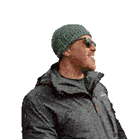 a man wearing a grey jacket and a green beanie is smiling