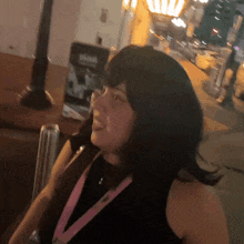 a woman with a lanyard around her neck that says ' i love you ' on it