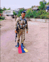 a man in a military uniform is holding a gun and a flag