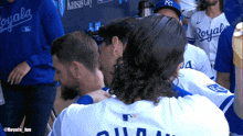 a group of royals baseball players huddle together
