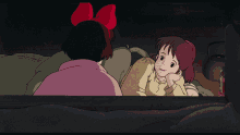 a girl with a red bow sits next to a girl with red hair