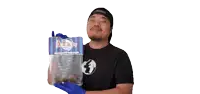 a man in a black shirt is holding a bag of baltimore ice cream