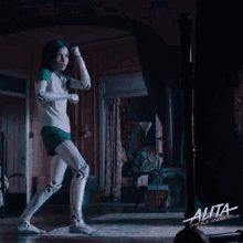 a movie poster for alita battle angel shows a woman in a green and white shirt
