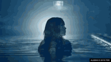 a woman is swimming in a pool with a fox logo on the bottom