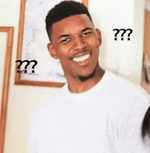 a man in a white shirt is smiling with a question mark above his head