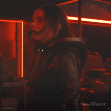 a woman is standing in a dark room with thunderbolts written on the bottom