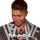 a man with a necklace and a jacket that says t-r-a-d-e.