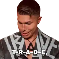 a man with a necklace and a jacket that says t-r-a-d-e.
