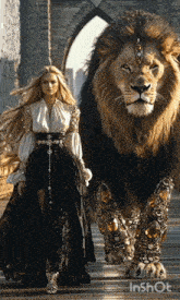 a woman in a long dress is walking next to a lion on a bridge
