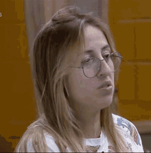 a close up of a woman wearing glasses and a shirt that says ' s ' on it