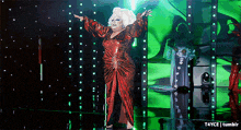 a drag queen in a red dress on a stage