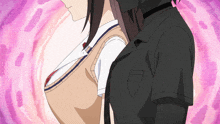 a man in a black shirt is hugging a woman in a brown vest