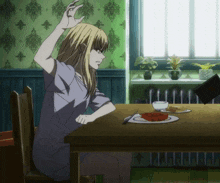 a woman sitting at a table with a plate of food