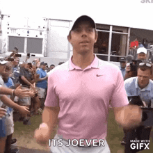 a man in a pink shirt says it 's joever in front of a crowd .