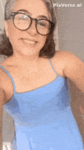 a woman wearing glasses and a blue dress is smiling with the words bat topissimo below her