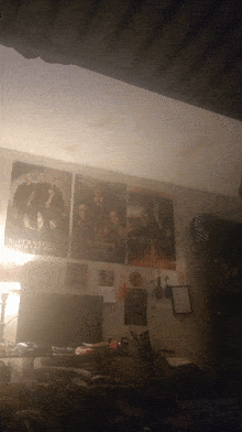 a poster for supernatural hangs on a bedroom wall