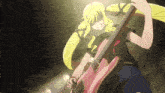 a girl is playing a pink guitar in a dark room