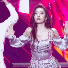 a woman is dancing on a stage with a man in a white shirt .