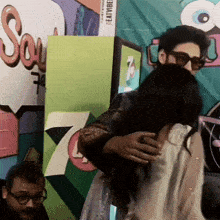 a man and woman hugging in front of a sign that says soul