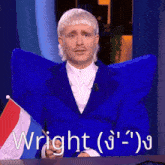 a man in a blue suit is sitting at a table with a flag and the word wright written on it