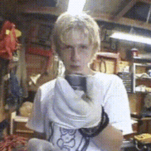 a man in a white shirt is holding a pair of shoes that say ' socks ' on them