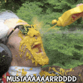 a man with mustard on his face and mustaaaaarrdddd written below