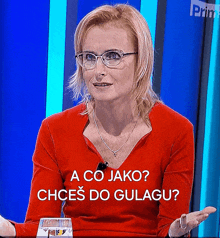 a woman wearing glasses and a red shirt that says a co jako