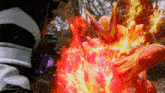 a cartoon character is surrounded by flames and a purple belt .