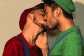 two men in mario and luigi costumes kissing