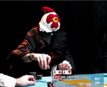 a person wearing a chicken hat is playing poker