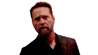 a man with a beard is wearing a black jacket and a black shirt