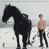 a shirtless man stands next to a black horse in the snow with a caption that says been scanning the stations searching for a song