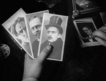 a black and white photo of a man wearing a top hat and glasses