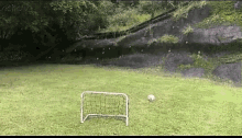 a soccer ball is going through a goal in a field