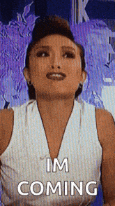 a woman in a white tank top says i 'm coming .