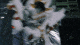a blurred image of a person 's face with a few pieces of paper flying in the air
