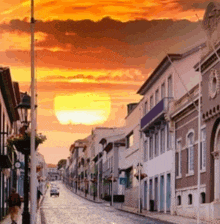 a sunset over a street with a sign that says ' avenida '