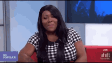 a woman is sitting in front of a sign that says shift