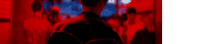 a blurry picture of a man standing in a crowd of people