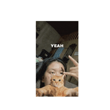 a picture of a girl holding a cat with the word yeah above her