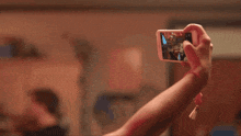 a woman taking a picture of herself with a can of bud light in her hand