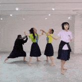 a girl wearing a pink shirt that says ' i love you ' on it dances with three other girls
